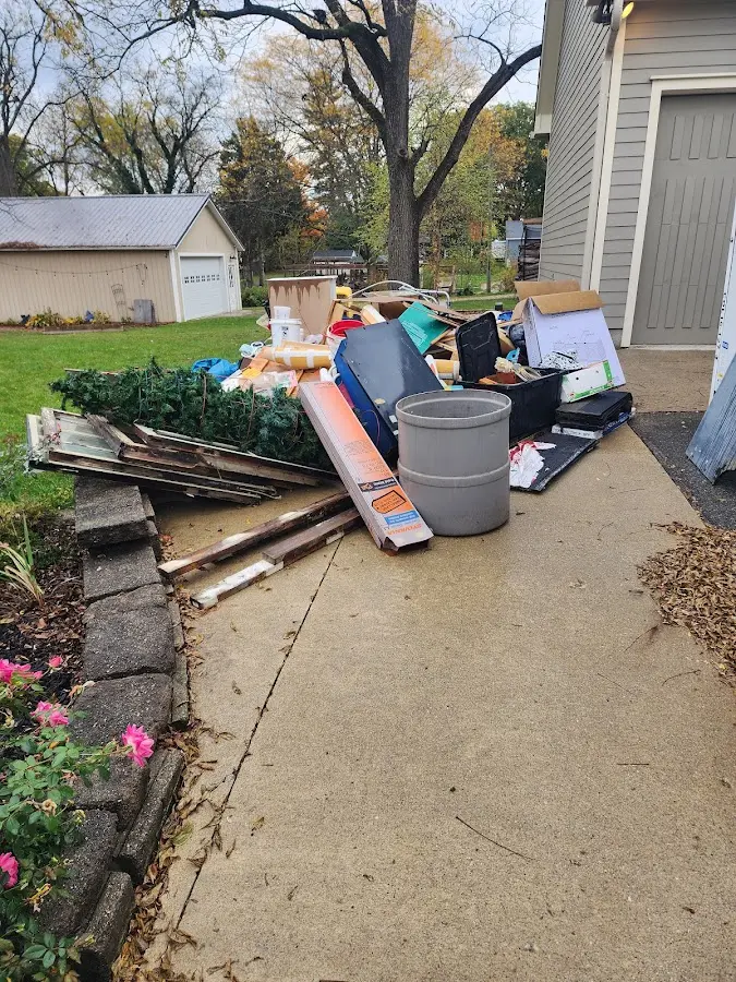 Dumpster being loaded with debris for 12 Yard Dumpster Rental in Fruita